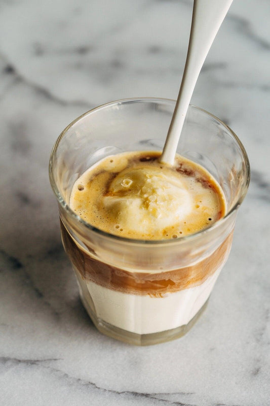 An afogato (ice cream with coffee in a small glass with a spoon)