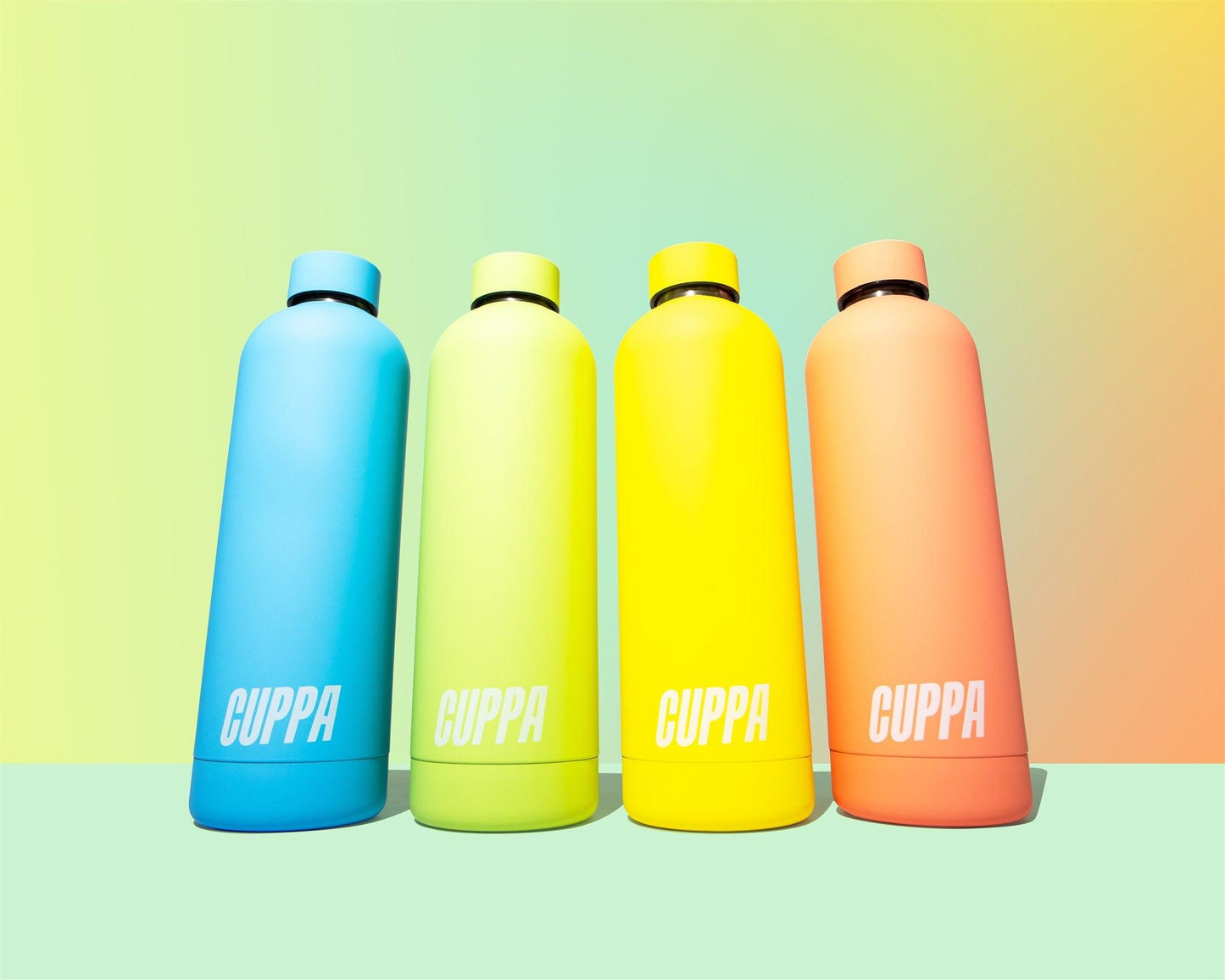 Cuppa water bottles in yellow blue green orange on mutli coloured rainbow gradient background landscape