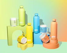 Load image into Gallery viewer, Cuppa mugs and cuppa insulated water bottles in orange yellow blue green on a mutli coloured background with rainbow effect in landscape
